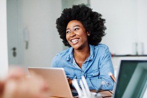 Woman smiling during work meeting in office