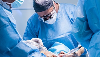 Oral surgery team placing dental implants