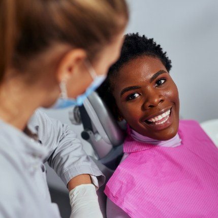 Person smiling at their dentist