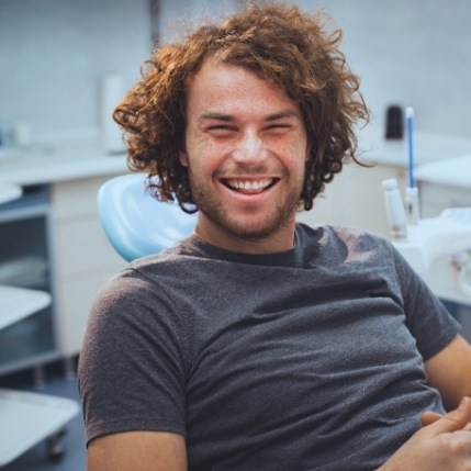 Laughing man sitting in dental chair