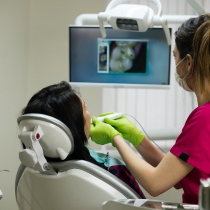 Dentist showing a patient images of their teeth using advanced dental technology in Catonsville