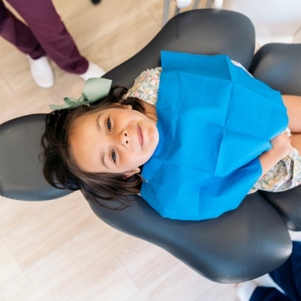 Young girl laying back in dental chair