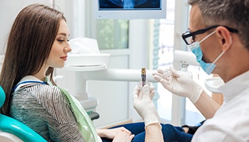 dentist explaining dental implant to patient 