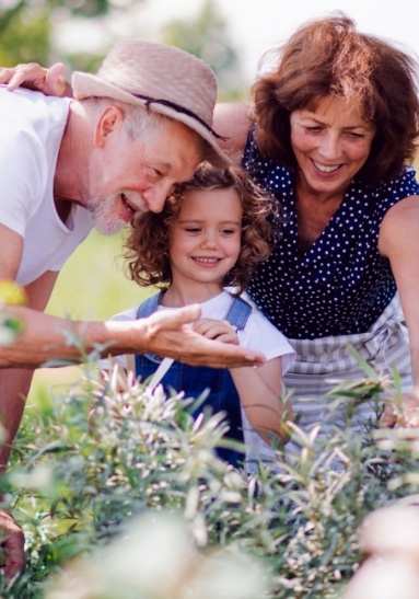 Family of three looking at flowers