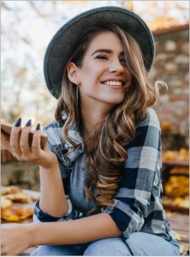 Woman in black and white plaid shirt outdoors in autumn