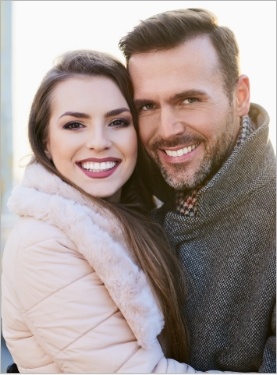 Smiling man and woman in winter coats