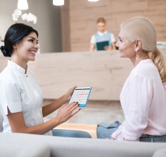 dental team member talking to patient