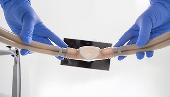 Looking up at blue-gloved hands removing nitrous oxide mask