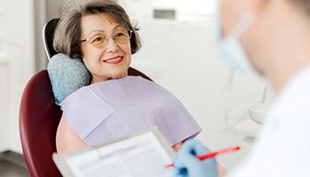 Dentist taking notes during patient’s consultation