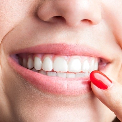 Close up of person pointing to their gums