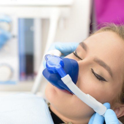 Young woman wearing mask for nitrous oxide sedation dentistry in Catonsville