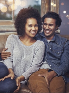 Man and woman sitting at table in front of window