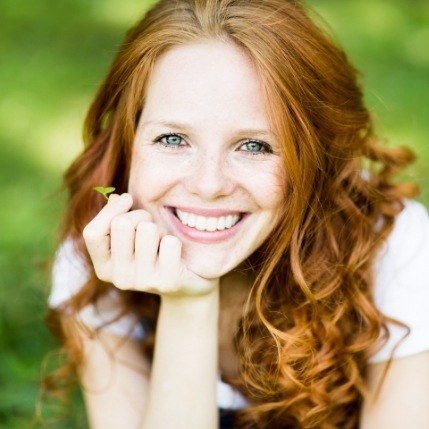 Redheaded woman with veneers in Catonsville smiling
