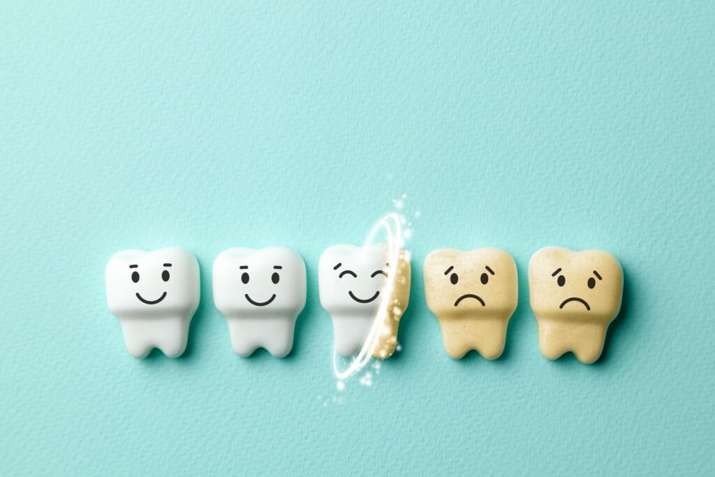Row of animated teeth that are happily being whitened