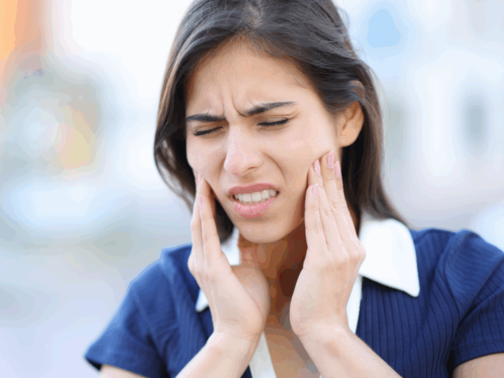 Woman holding jaw in pain